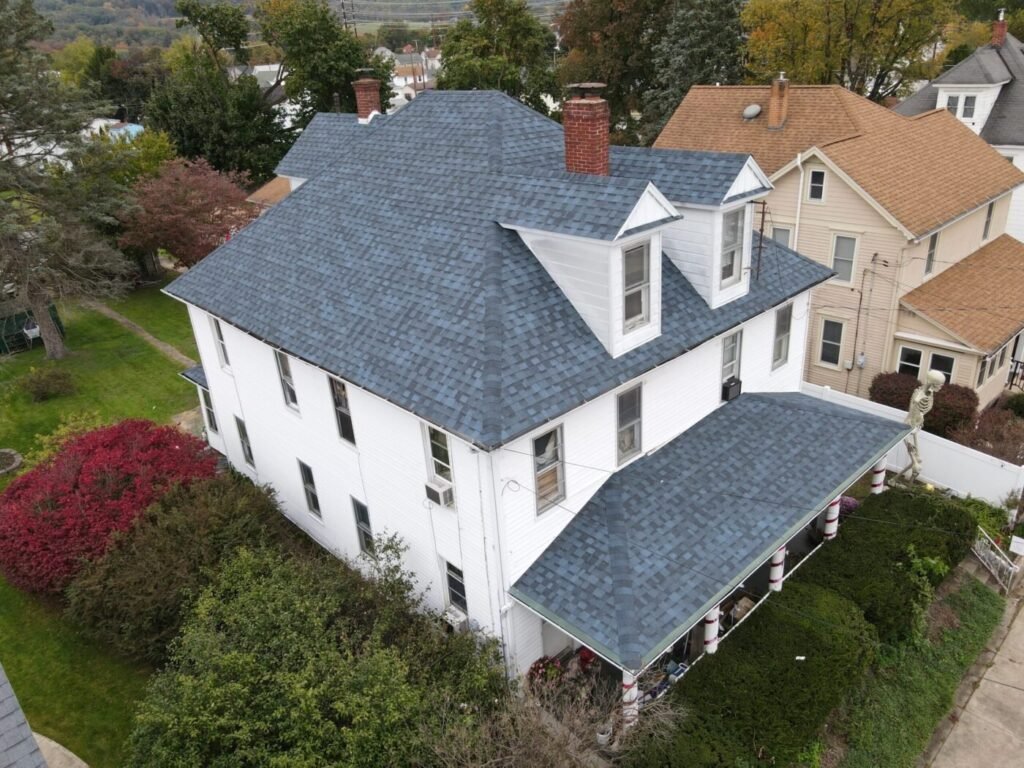 Large residential home with a newly installed blue shingle roof.