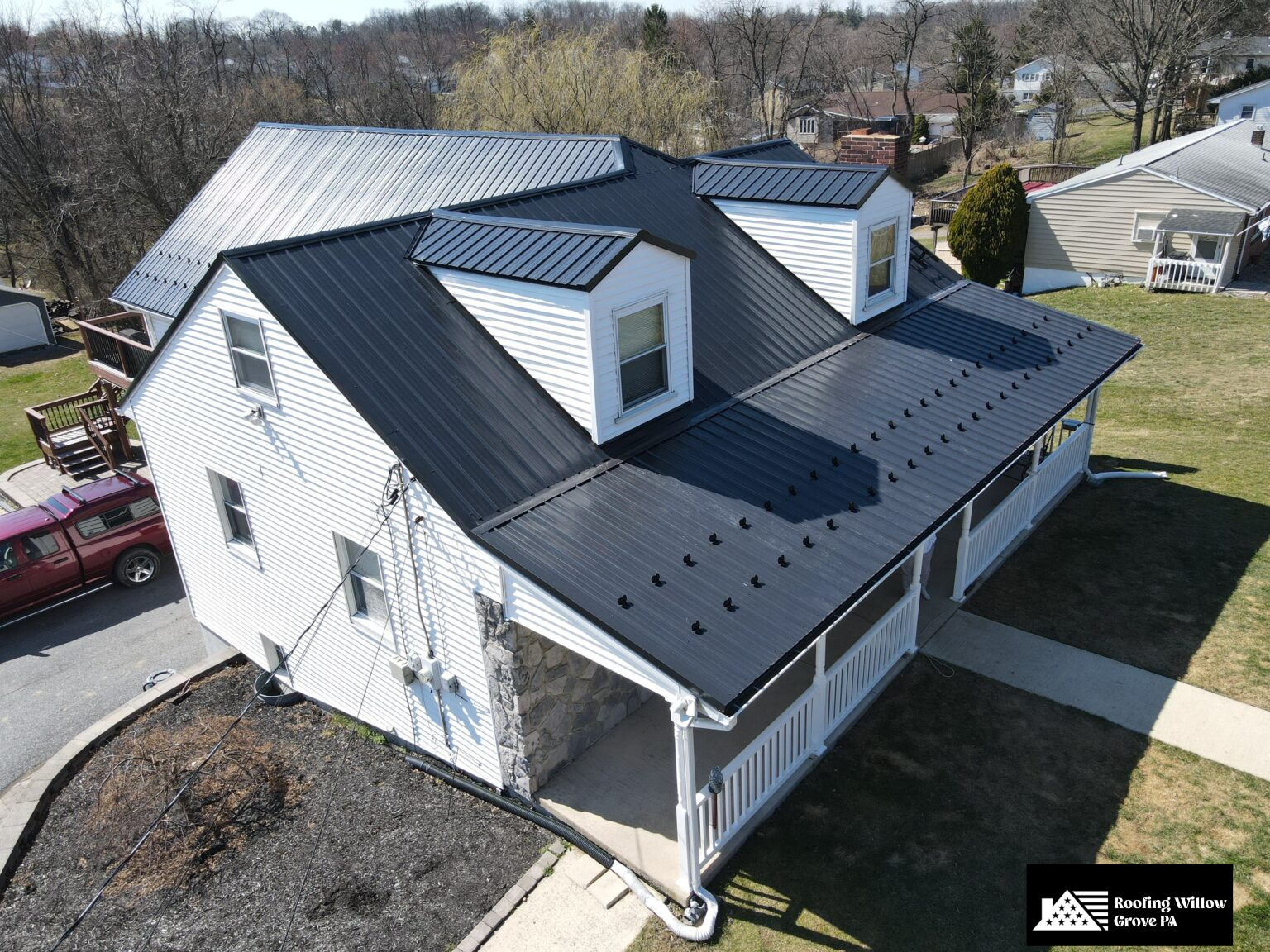 Modern home with sleek black metal roofing for enhanced durability.