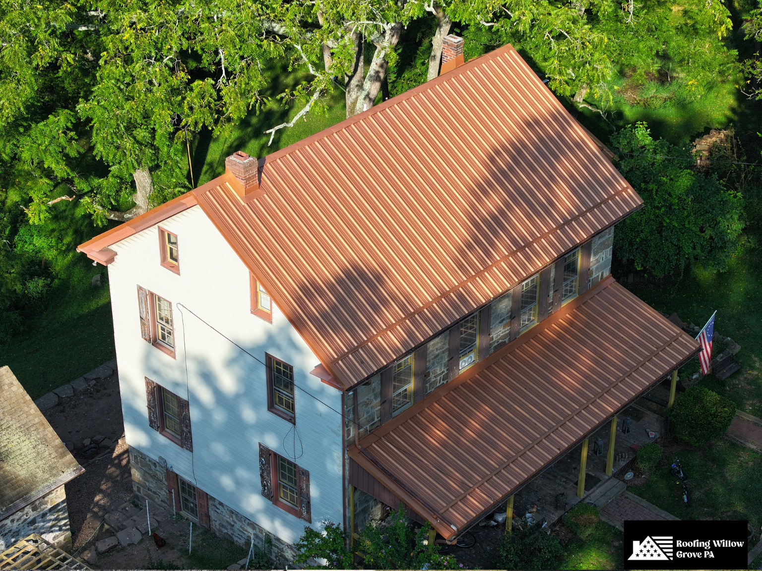 Traditional home with stylish copper-colored metal roofing.