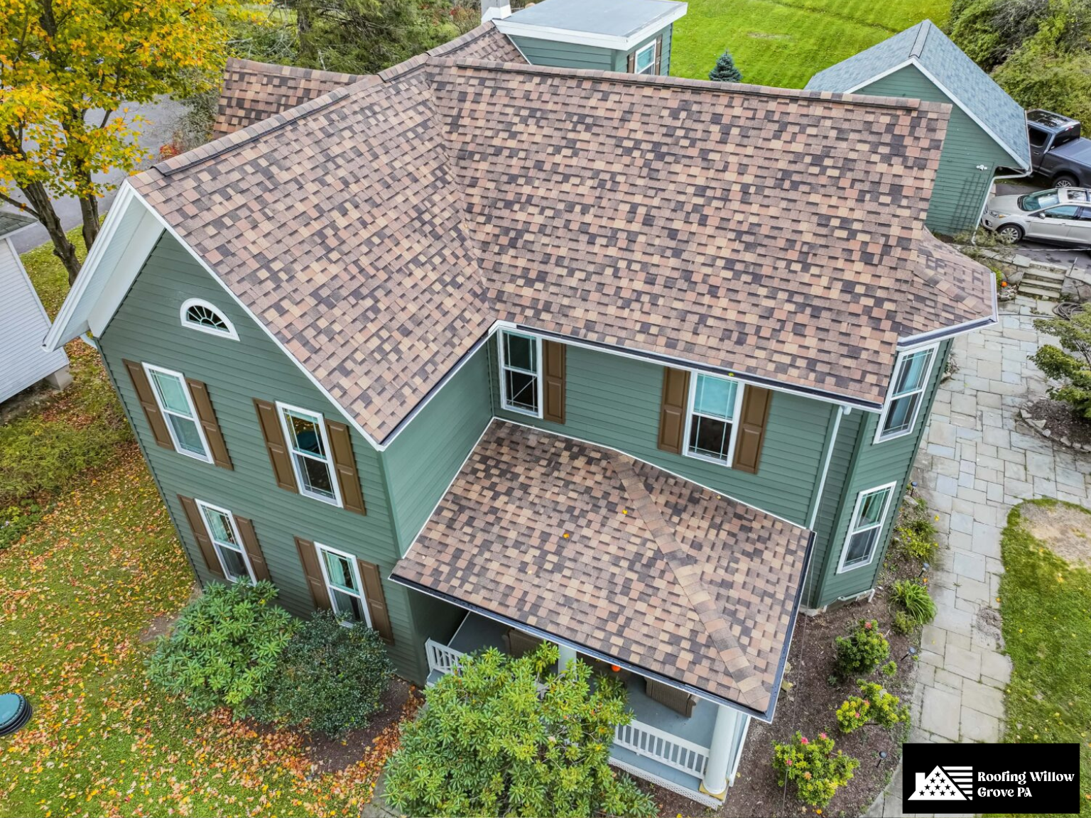 Classic home with a multi-colored asphalt shingle roof installation.